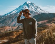 Trendy man standing in front of a mountain