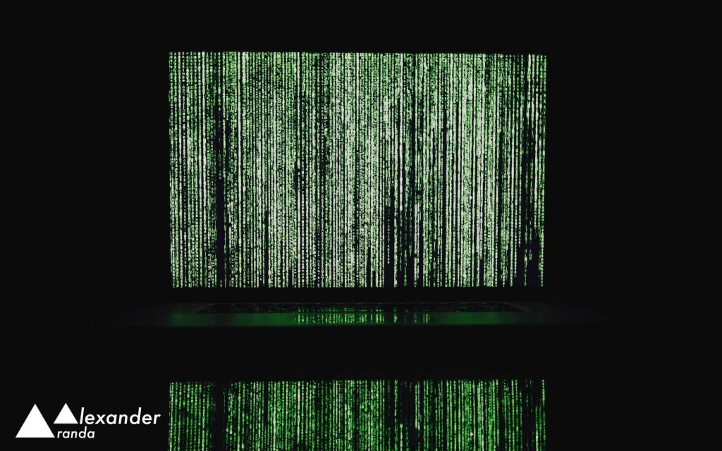 Laptop displaying falling green text from The Matrix movie
